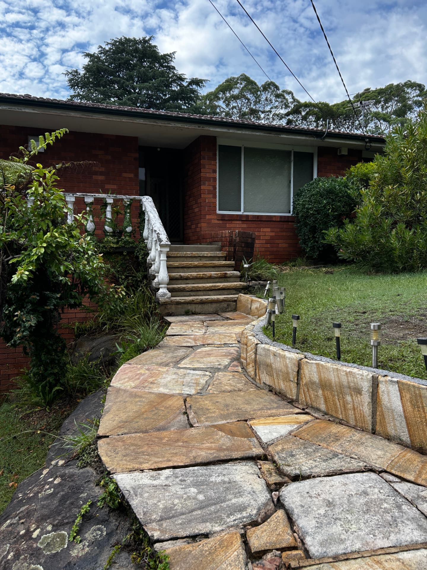 Sandstone entry path and retaining wall cleaned to show the natural stone colour