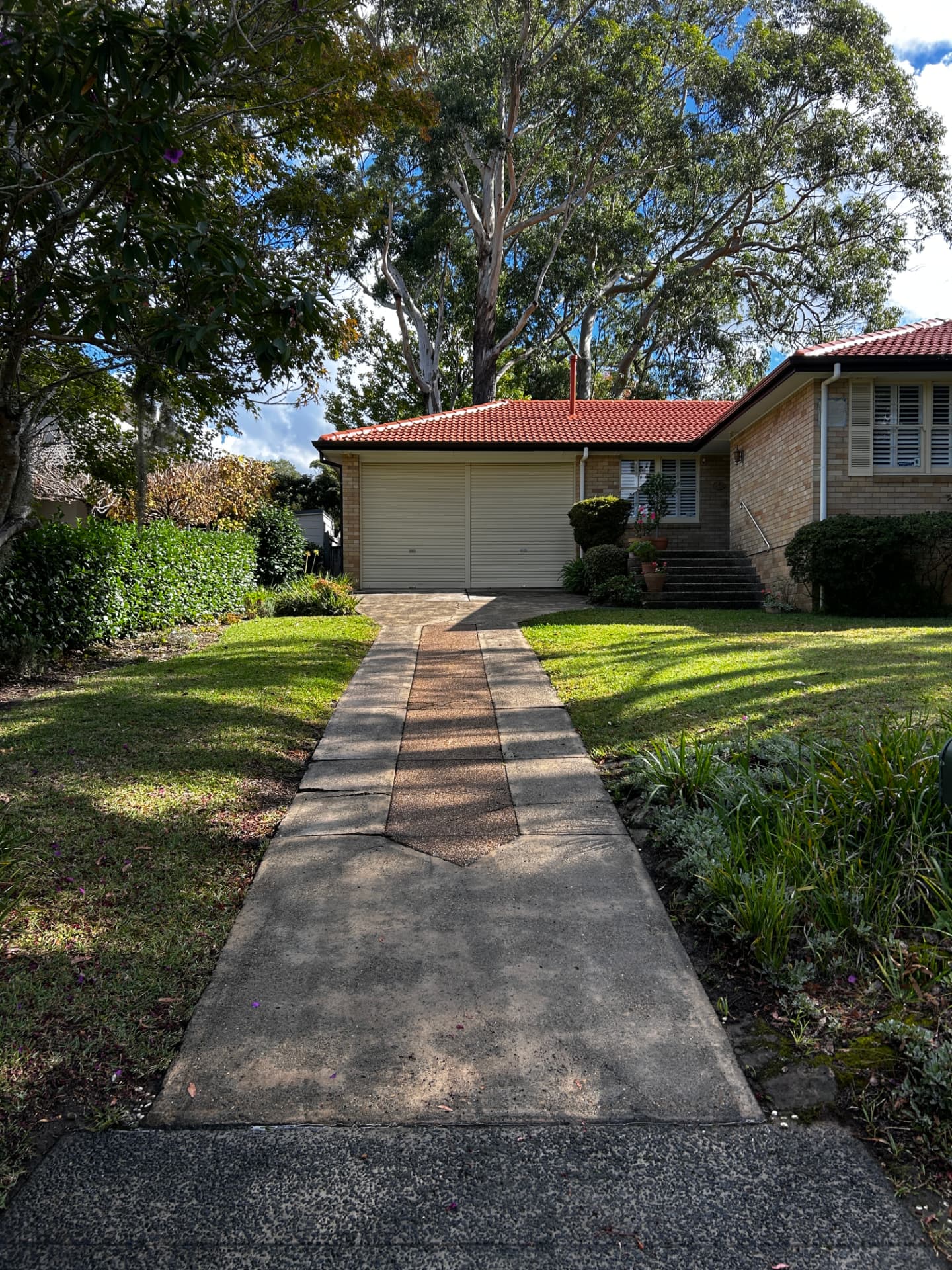 Concrete front path cleaned evenly from the street to the garage