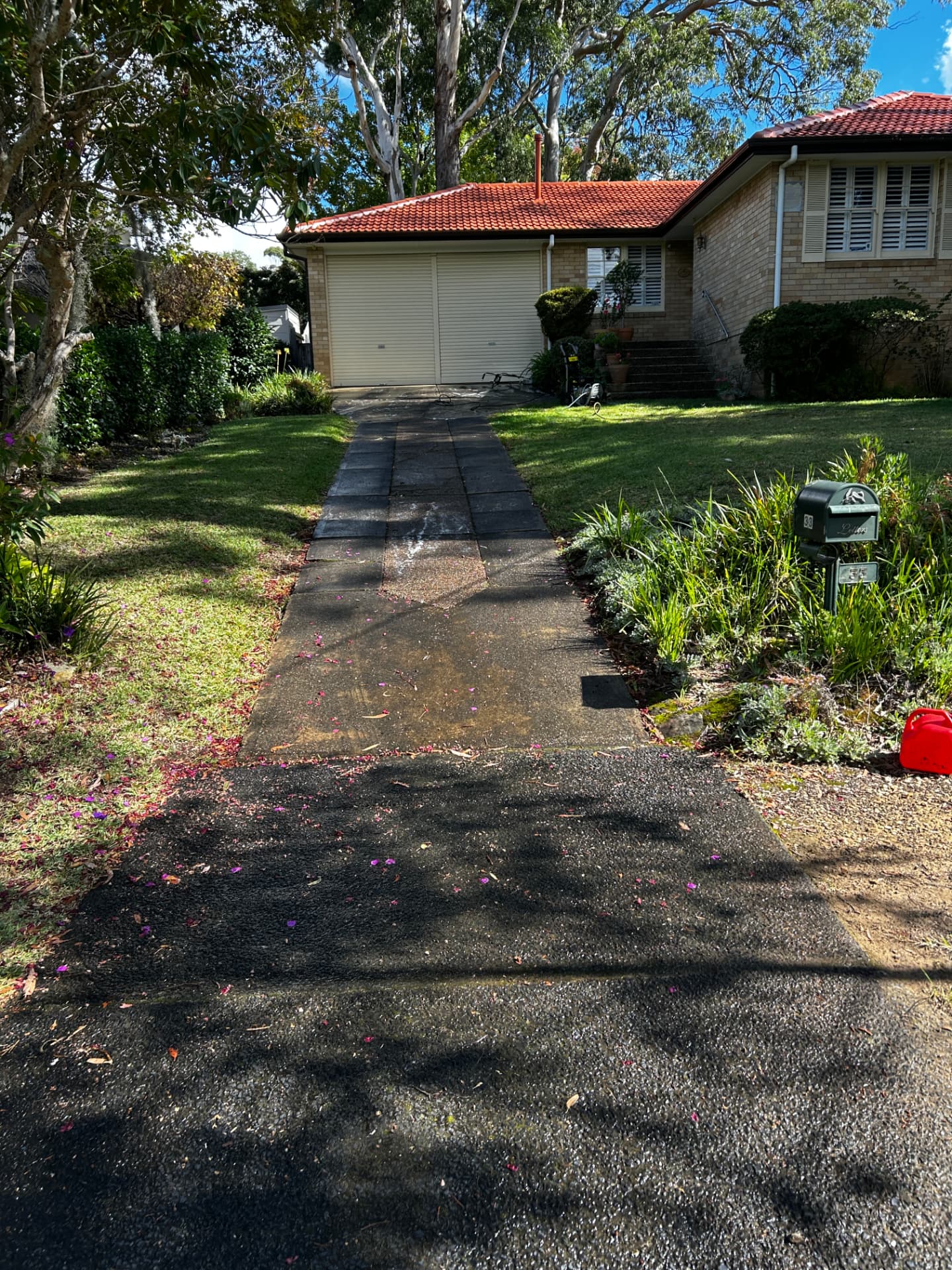 Stained concrete front path leading to a Sydney home before cleaning