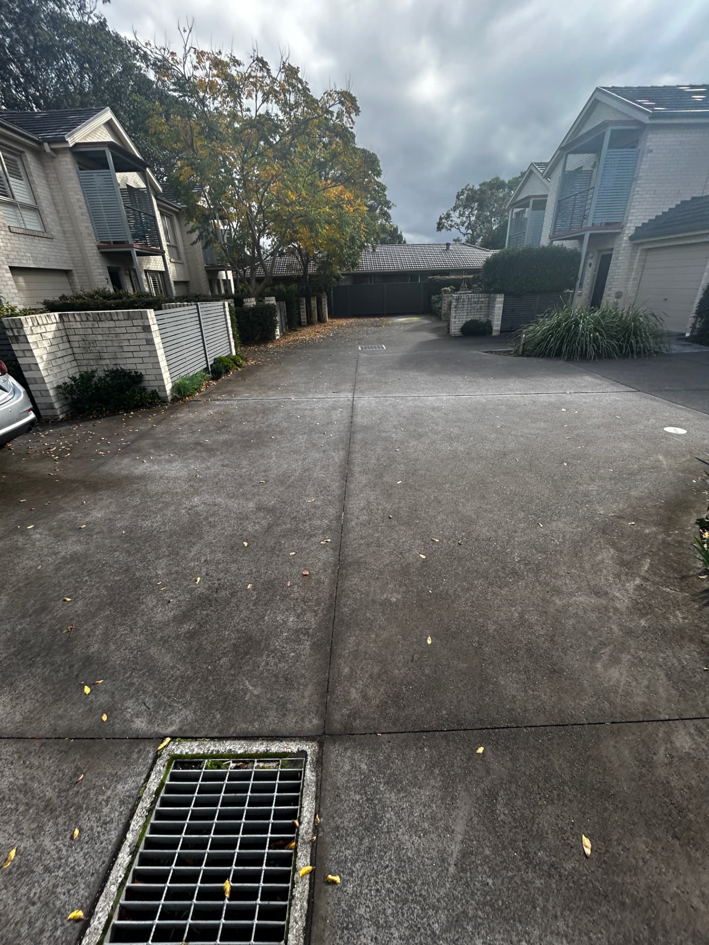 Shared townhouse driveway in Sydney darkened with dirt and grime before pressure washing