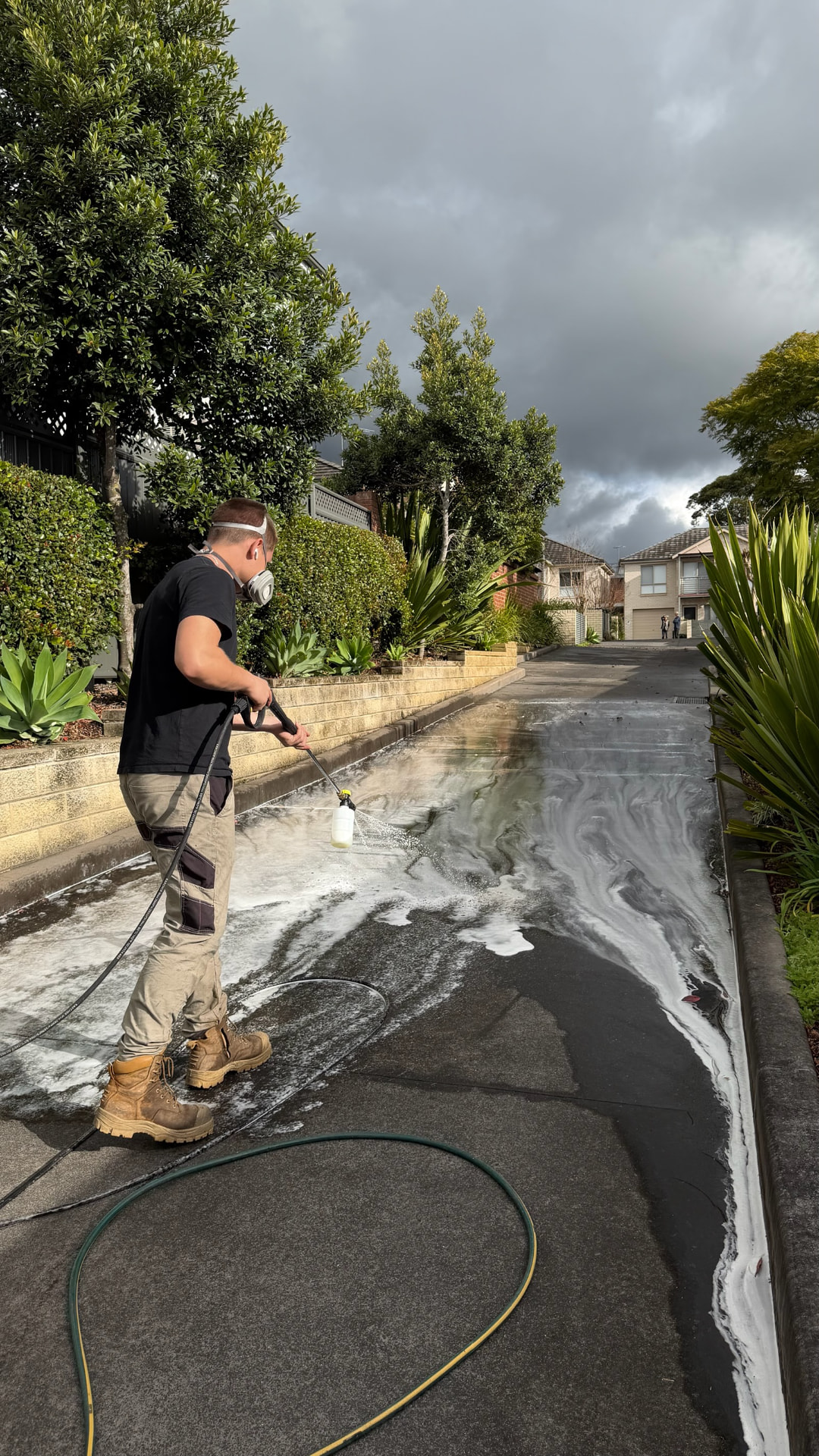 True Clean applying cleaning solution to a Sydney driveway